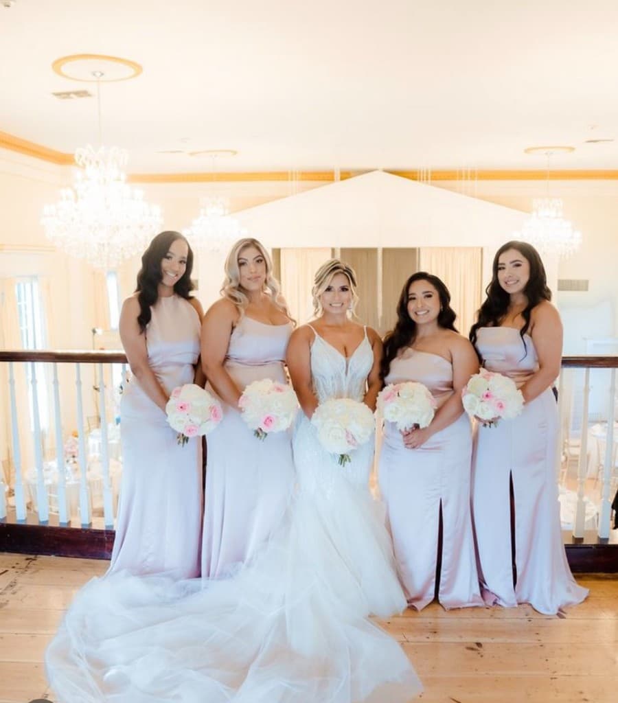 Bridesmaids in lavender under chandeliers