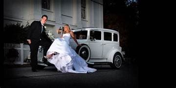 Couple with vintage car at night
