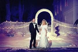 Couple at winter gate with lights