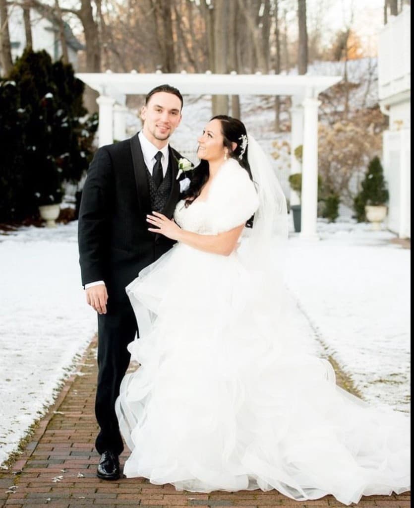 Couple at snow-covered pergola in winter