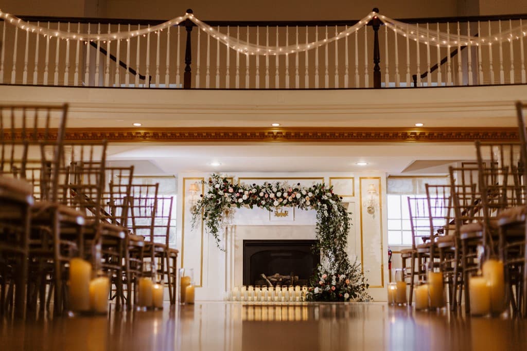 Ceremony at fireplace with candles and florals
