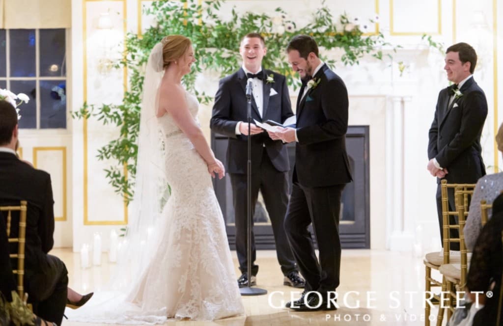 Indoor ceremony with greenery backdrop