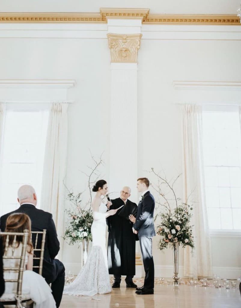 Couple exchanging vows at indoor ceremony