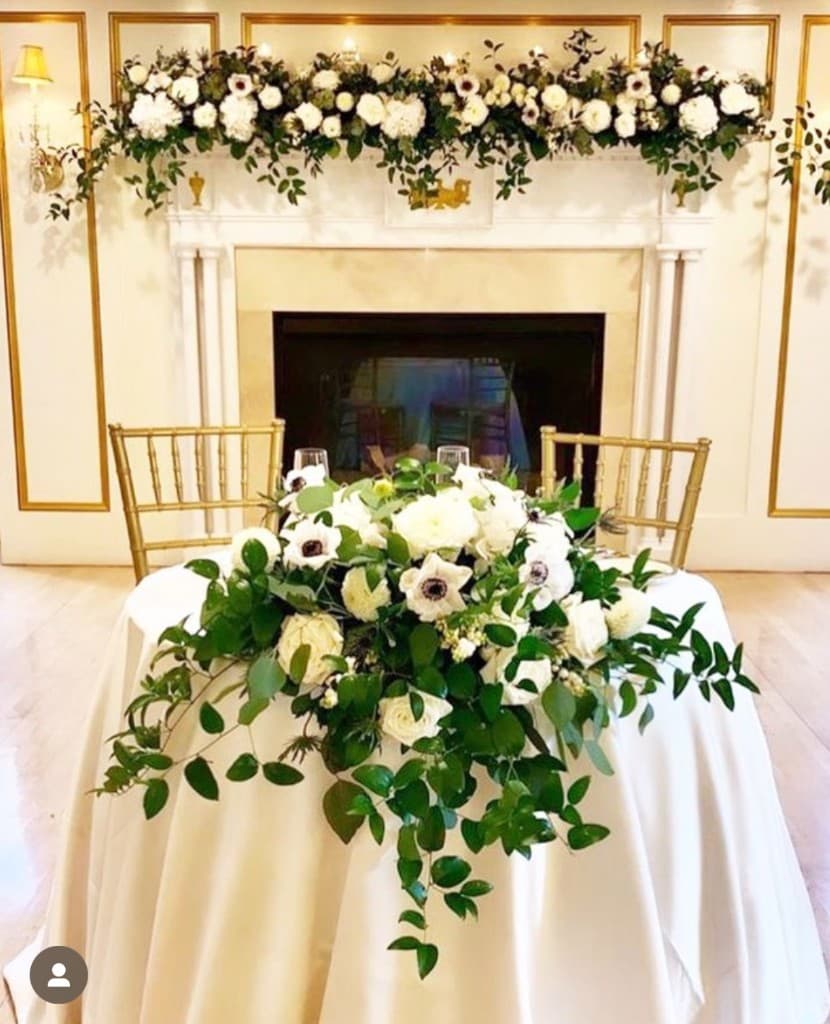 Sweetheart table with white floral arrangements