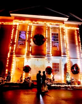Venue exterior with holiday lights at night