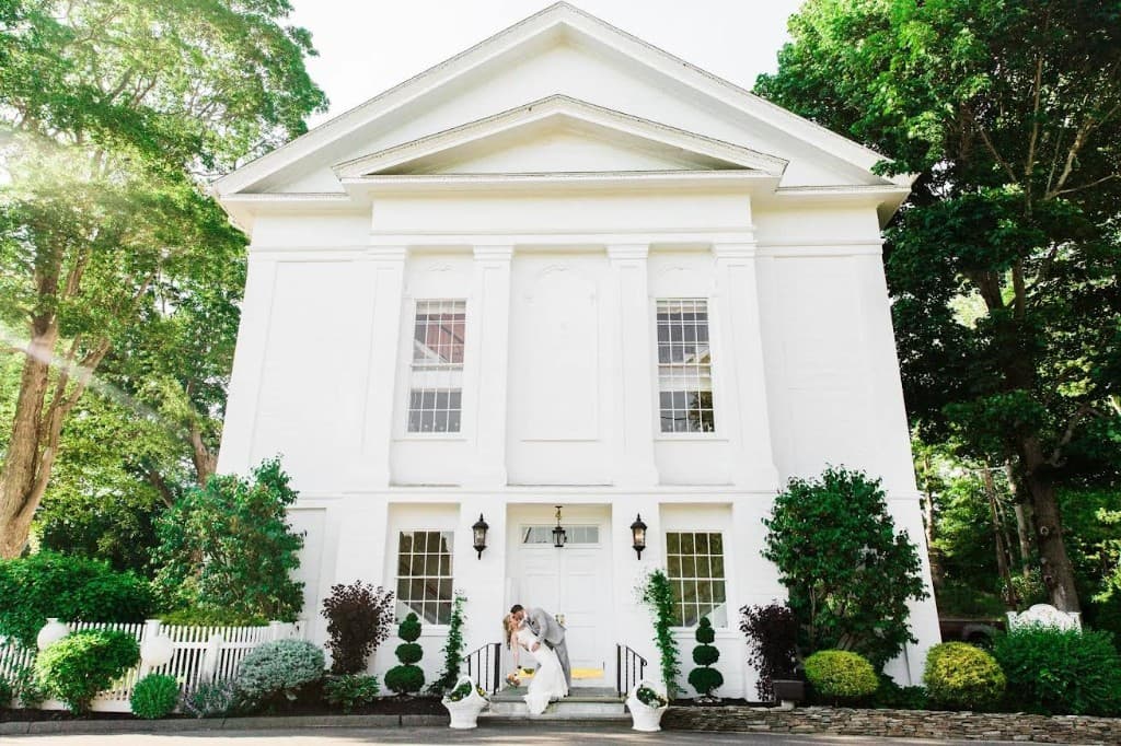 The Commons 1854 — North Shore's premier historic wedding venue in Topsfield Massachusetts, couple on front steps
