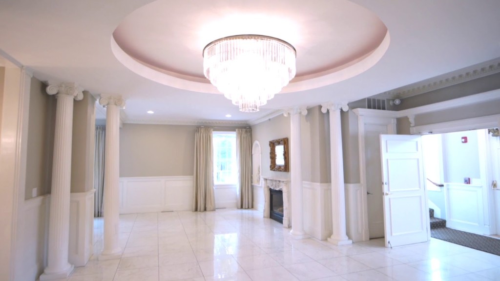 The Rotunda at The Commons 1854 — Swarovski chandelier, Ionic columns with capitals, porcelain Carrara floors, fireplace